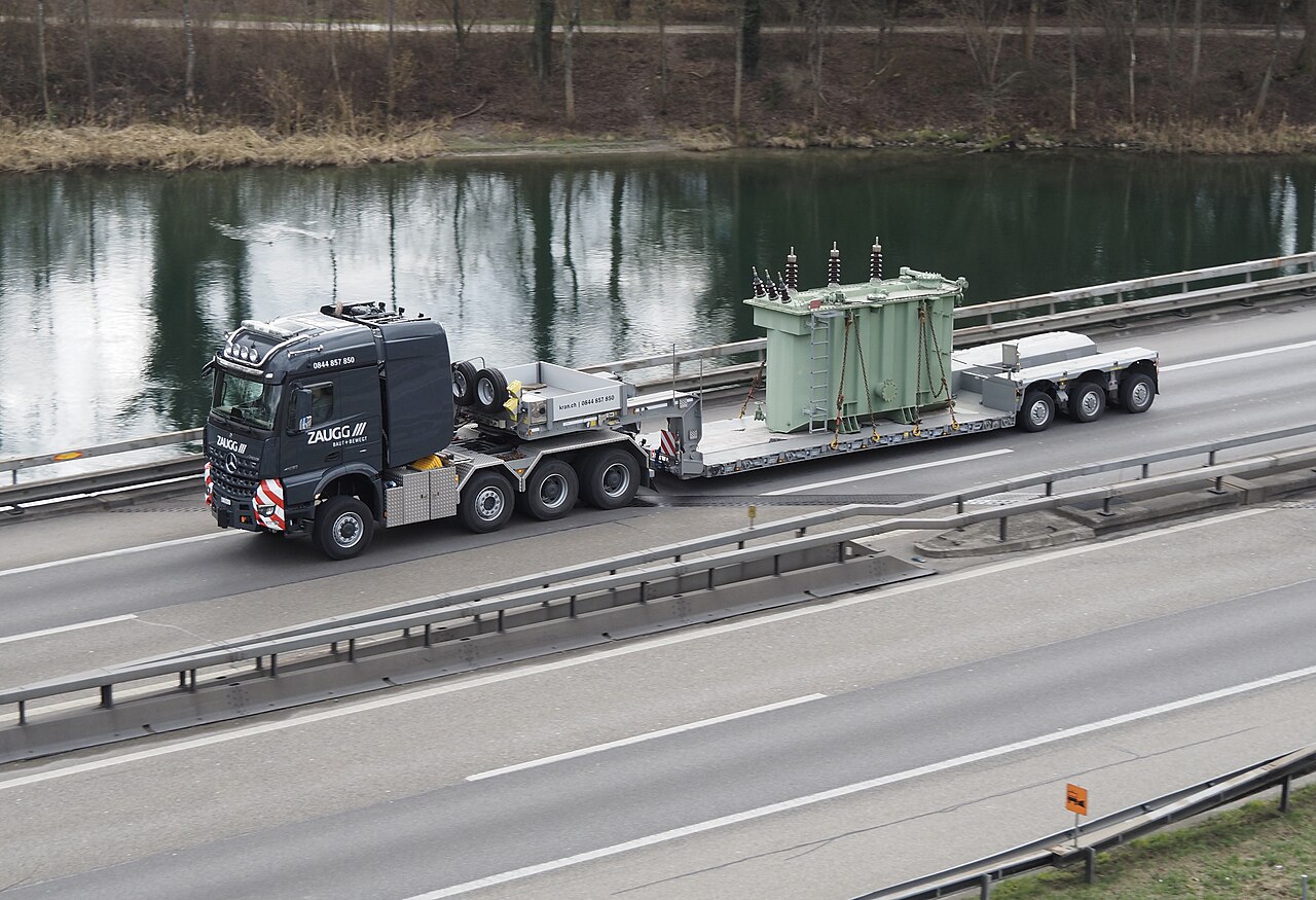 Heavy haulage lowboy trailer transporting an industrial transformer